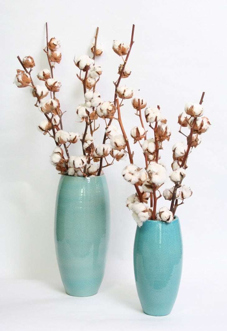 5 cotton branches with 5 and 8 balls in a turqoise vase